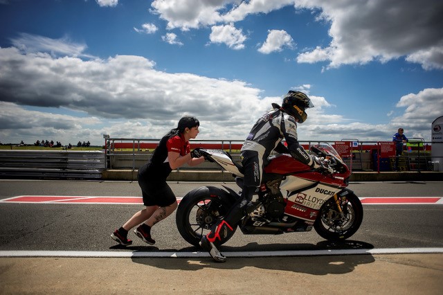 working as a motorcycle race technician on pit lane